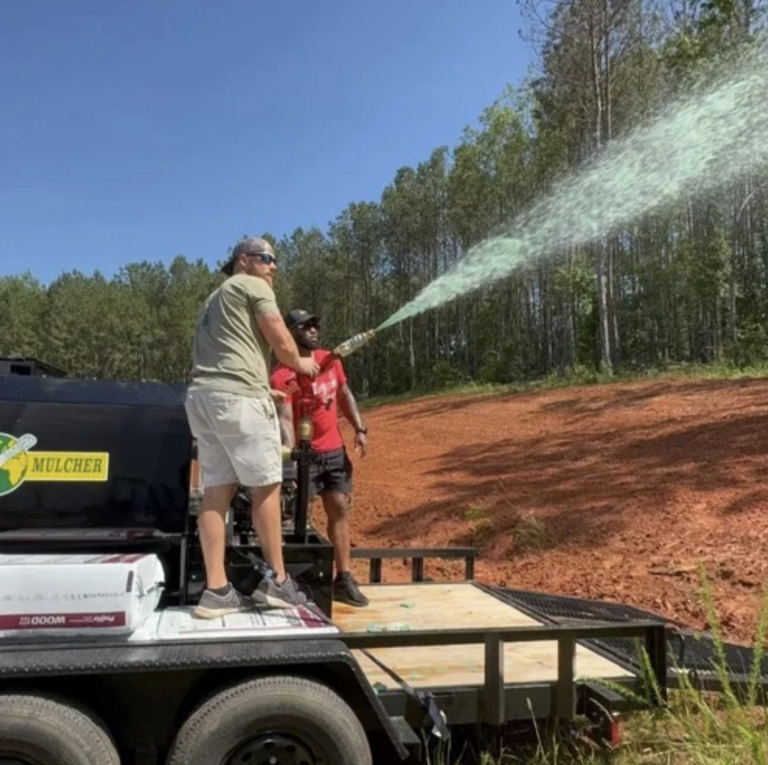 Super Seed crew applying hydroseed slurry from the trailer — Upstate SC